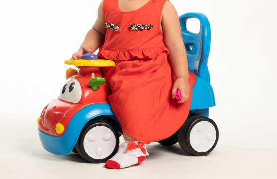 toddler riding a car
